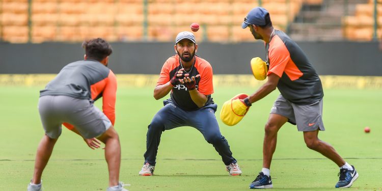 Indian players including Cheteshwar Pujara (C) go through their fielding drills, Wednesday