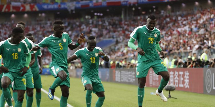 Senegal's Mbaye Niang (R) dances in celebration with his teammates after scoring the winner against Poland at the Spartak Stadium in Moscow, Russia
