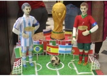 The statues of Lionel Messi, Cristiano Ronaldo and the World Cup trophy made out of sweetmeats at Kolkata
