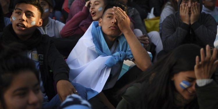 Stunned Argentina fans lament the loss of their team in Buenos Aires, Thursday 