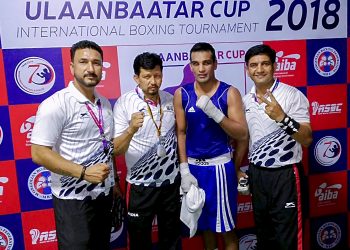 Indian boxer Mandeep Jangra (in blue) poses with officials after winning his quarterfinal bout against Batkhuyag Sukhkhuyag in Mongolia, Friday  