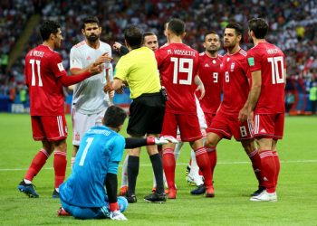 Referee Andres Cunha (in yellow) steps in to diffuse the situation after the alleged stamping ‘row’ between Diego Costa (in grey) and Iran keeper Ali Beiranvand (in blue)