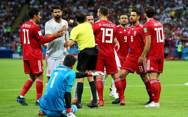 Referee Andres Cunha (in yellow) steps in to diffuse the situation after the alleged stamping ‘row’ between Diego Costa (in grey) and Iran keeper Ali Beiranvand (in blue)