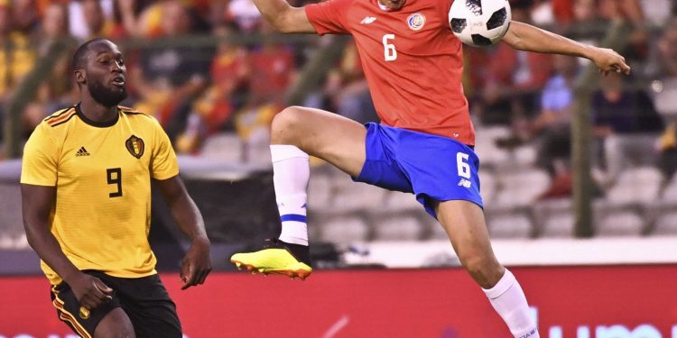 Costa Rica's Oscar Duarte (in red) goes up against Belgium's Romelu Lukaku during their friendly match at the King Baudouin stadium in Brussels