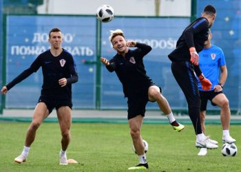 Ivan Rakitic (C) tries to connect a header as teammate Ivan Perisic (L) looks on during Croatia’s training session at the Roshchino Arena near St Petersburg