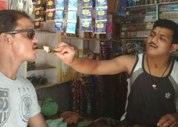 Abhinash Swain helps a customer try a fire paan