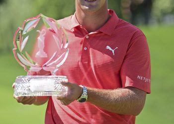 Bryson DeChambeau poses with the trophy after winning the Memorial Golf Tournament, Sunday