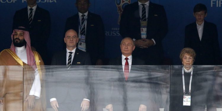 FIFA President Gianni Infantino (2nd from L) and Russian President Vladimir Putin (2nd from R) stand for the anthem before to the opening match at the Luzhniki stadium in Moscow, Thursday