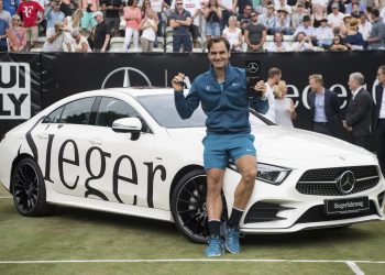 Roger Federer poses with the winner’s trophy at Stuttgart, Sunday