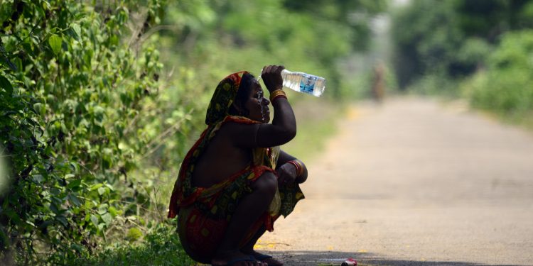 A woman on the outskirts of the city splashes water on her face to get respite from blistering heat
Pic: Bikash Nayak