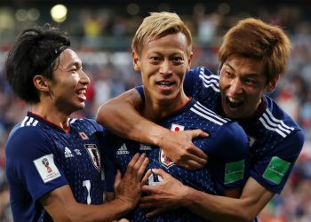 Keisuke Honda (C) is surrounded by his teammates after scoring Japan’s second goal against Senegal, Sunday