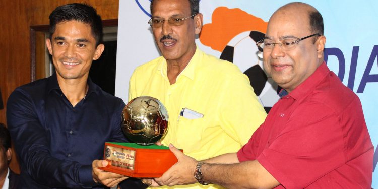 AIFF vice-president Subrata Dutta hands the Indian player of the year award to Sunil Chhetri as former national player Subrata Bhattacharya looks on in Kolkata, Tuesday