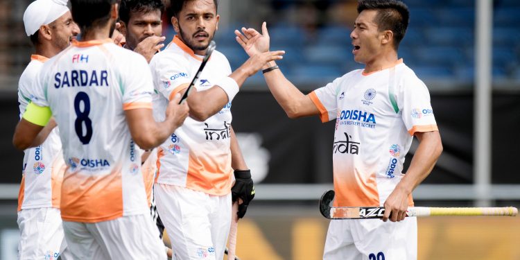Teammates congratulate Harmanpreet Singh (C) after he scored the first goal for India against Argentina in their Champions Trophy group encounter, Sunday   