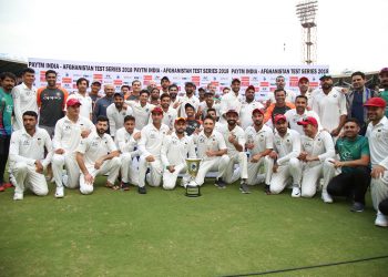 India and Afghanistan players pose with the trophy after the match at Bangalore, Friday