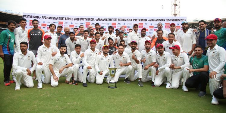 India and Afghanistan players pose with the trophy after the match at Bangalore, Friday