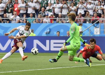 Mexico’s Javier Hernandez shoots to score the second goal for his side against South Korea, Saturday