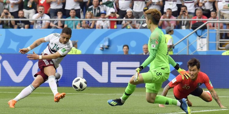 Mexico’s Javier Hernandez shoots to score the second goal for his side against South Korea, Saturday