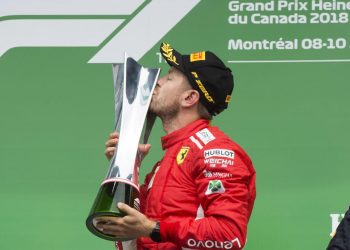 Sebastian Vettel kisses the winner’s trophy in Montreal, Sunday