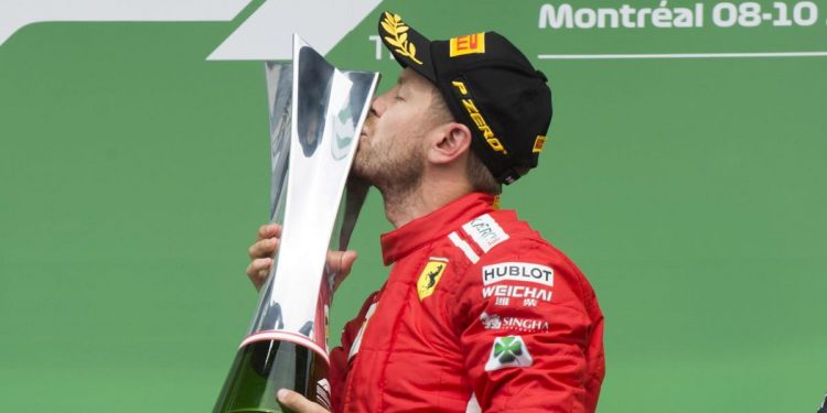 Sebastian Vettel kisses the winner’s trophy in Montreal, Sunday