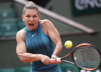 Simona Halep returns the ball to Elise Mertens during their fourth round match of the French Open tennis tournament at the Roland Garros stadium, Monday