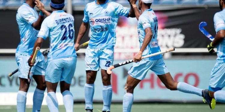 Varun Kumar (2nd right) is congratulated by teammates after scoring India’s first goal against Australia, Wednesday