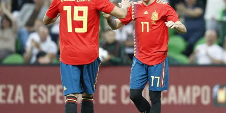 Spain’s Iago Aspas (R) celebrates with teammate Diego Costa after scoring the winning goal against Tunisia, Saturday