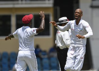 West Indies’ Roston Chase (R) celebrates with teammates after dismissing a Sri Lanka batsman at Port of Spain, Sunday