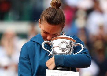 Simona Halep holds tight the Suzanne-Lenglen Cup after winning the French Open women’s singles title, Saturday