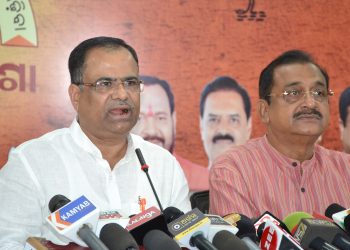 BJP spokesperson Pitambar Acharya (L) addresses the media in Bhubaneswar as party leader Samir Mohanty shares the dais.