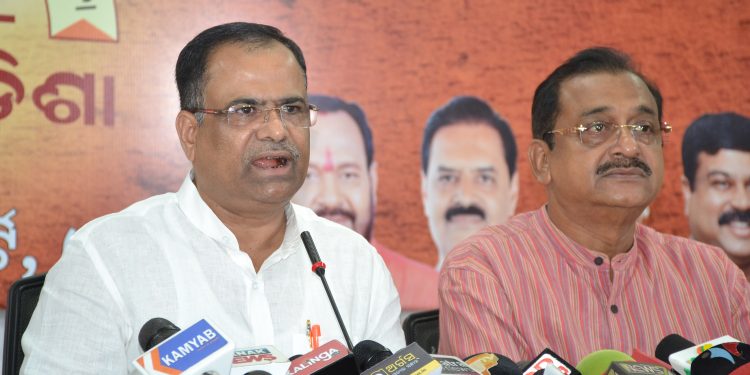 BJP spokesperson Pitambar Acharya (L) addresses the media in Bhubaneswar as party leader Samir Mohanty shares the dais.