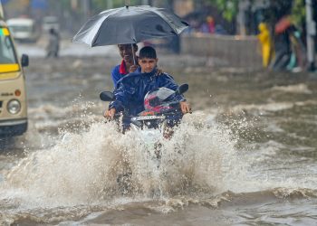 Mumbai: A motorcyclist wades through a water-logged street at King Circle after heavy rains in Mumbai on Saturday, June 09, 2018. (PTI Photo/Shashank Parade) (PTI6_9_2018_000064B)