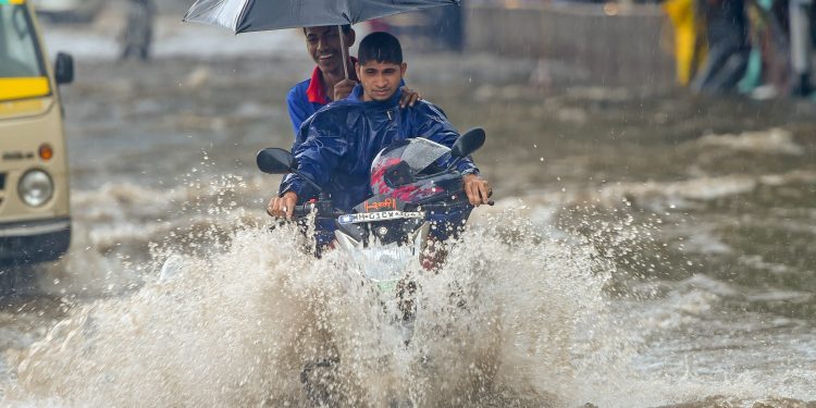 Mumbai: A motorcyclist wades through a water-logged street at King Circle after heavy rains in Mumbai on Saturday, June 09, 2018. (PTI Photo/Shashank Parade) (PTI6_9_2018_000064B)