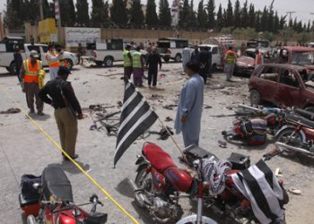 Pakistani volunteers and security officers visit the site in Quetta, Wednesday.