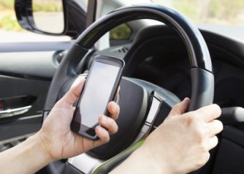 smart phone in hand  while driving