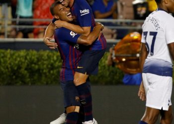 Arthur Melo (R) celebrates with teammate Rafinha after scoring on his maiden appearance for Barcelona against Spurs, Saturday