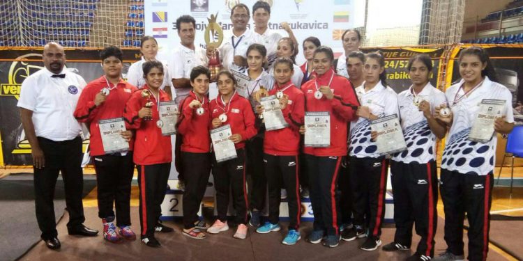 Indian players pose with their medals, certificates and winners’ trophy along with officials in Subotica, Serbia, Monday