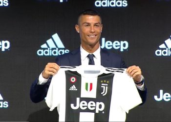 Cristiano Ronaldo poses with his Juventus jersey during his unveiling in Turin, Monday