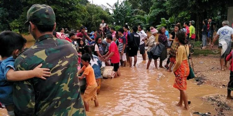 Villagers carry their belonging as they evacuate after the Xepian-Xe Nam Noy hydropower dam collapsed in Attapeu province, Laos. REUTERS/Stringer