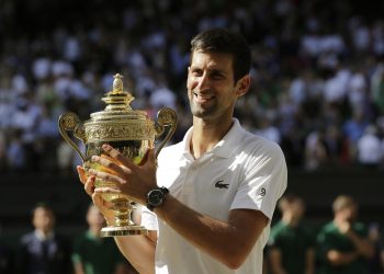Novak Djokovic holds the trophy after defeating Kevin Anderson of South Africa in the men's singles final match at the Wimbledon Tennis Championships in London, Sunday