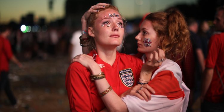 England fans react after their loss against Croatia in the World Cup semifinal in Hyde Park, London, Wednesday