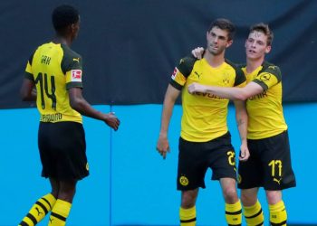 Christian Pulisic (C) is congratulated by his Dortmund teammates after scoring against Liverpool, Sunday