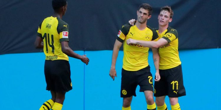 Christian Pulisic (C) is congratulated by his Dortmund teammates after scoring against Liverpool, Sunday
