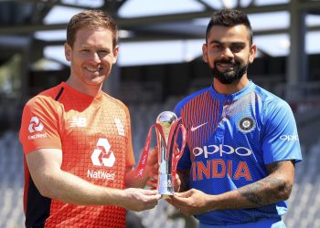 England's Eoin Morgan (L) and India's Virat Kohli pose with the series trophy at The Old Trafford in Manchester, Monday