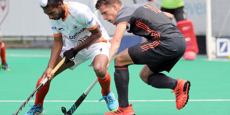 Mandeep Mor (L) the man who scored both the goals for India, trying to get past a Dutch player, Saturday 