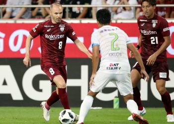Andres Iniesta (L) in action during his J-League debut with Vissel Kobe