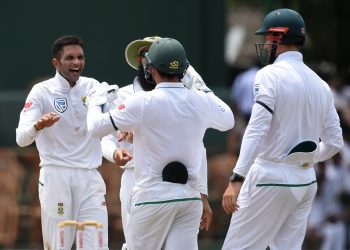 Keshav Maharaj (L) celebrates with South African mates after dismissing a Sri Lankan batsman, Friday 