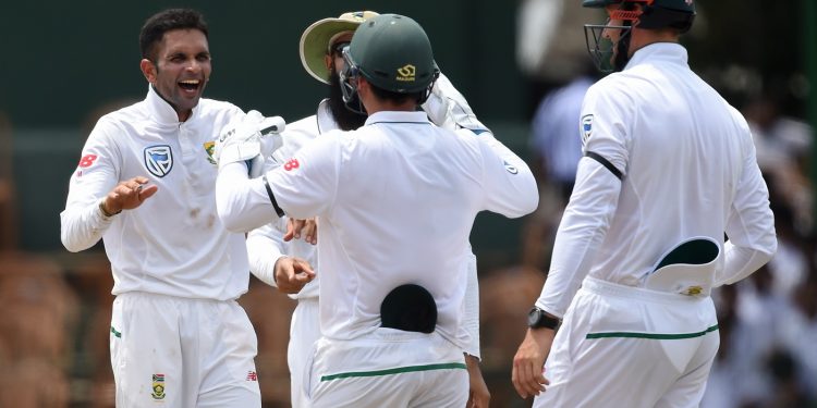 Keshav Maharaj (L) celebrates with South African mates after dismissing a Sri Lankan batsman, Friday 