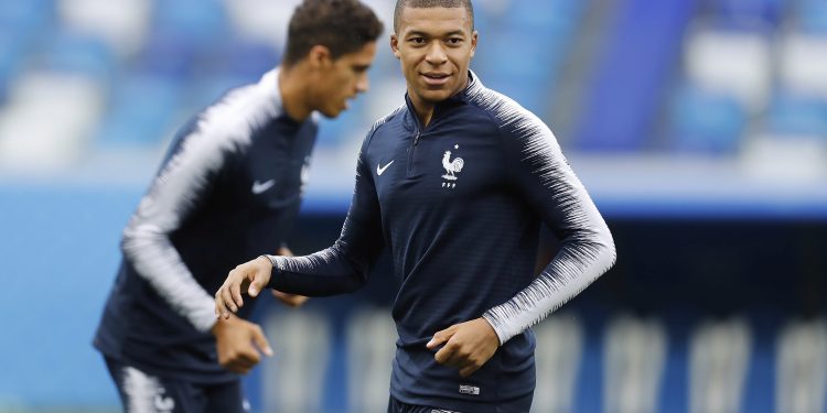 Kylian Mbappe smiles as he warms up during France's training session at Nizhny Novgorod