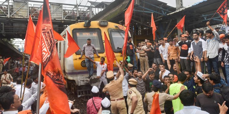 Thane: Maratha Kranti Morcha protesters stop a train during their statewide bandh, called for reservations in jobs and education, in Thane on Wednesday, July 25, 2018. (PTI Photo/Mitesh Bhuvad) (PTI7_25_2018_000062B) *** Local Caption ***