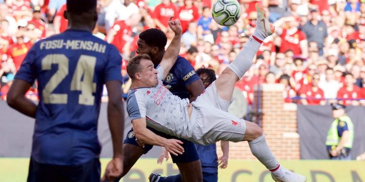 Xherdan Shaqiri (C) scores from an overhead bicycle-kick against Manchester United, Saturday